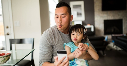 A man taking a silly selfie with his young daughter that he has conservatorship of.