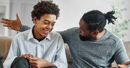 Younger man and older guardian laughing