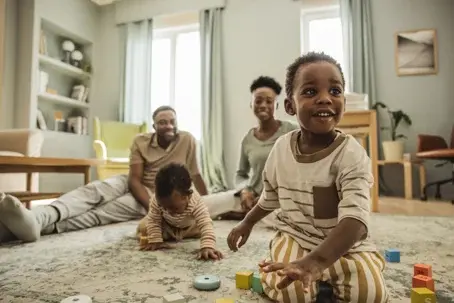 children playing with parents watching in the background