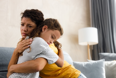mother hugging sad daughter