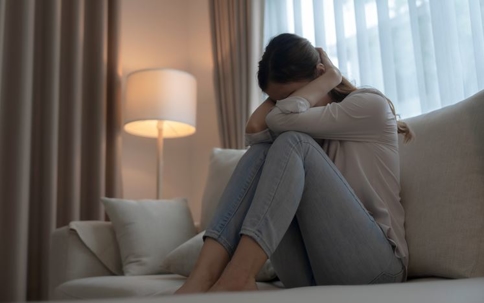 Woman crying on the couch