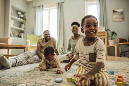 children playing with parents watching in the background