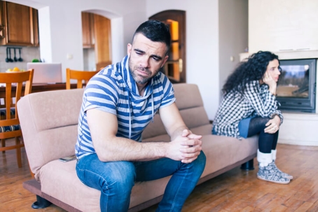 unhappy couple on couch