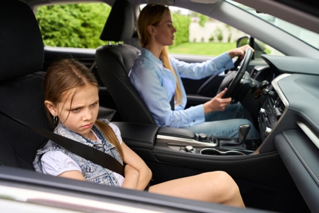 unhappy daughter and mother in car