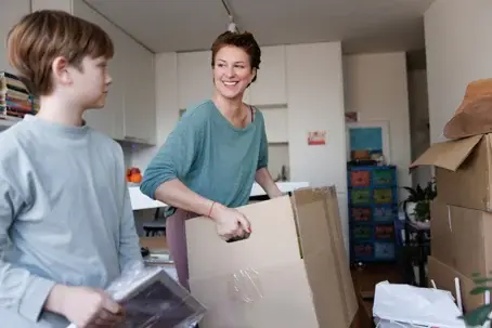 mother and son packing boxes